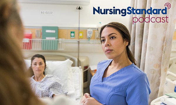 A nurse standing next to a patient's bed appears anxious as she listens to someone who is out of camera