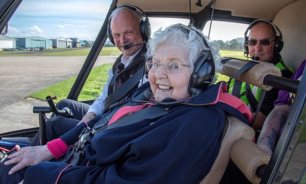 Stroud care home resident Ruby Wakefield in the cockpit of a helicopter: positive risk-taking can boost health and well-being