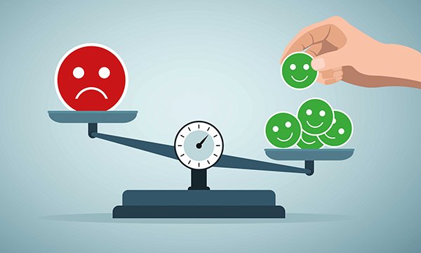 Illustration of weighing sometimes conflicting interests in nursing care of patient choice against harm prevention shows scales with one frowny face on one side outweighed by multiple, smaller smiley faces