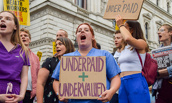 Photo of nurse protesting for more pay, illustrating story about imminent nurses's strike
