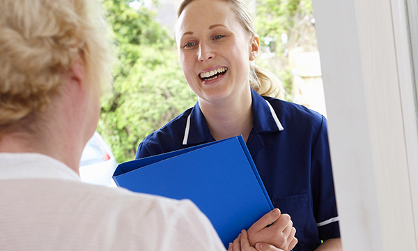 Photo of community nurse visiting a patient at home, illustrating a story about new standards for their training