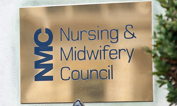 Brass name plaque at the entrance of the NMC building 