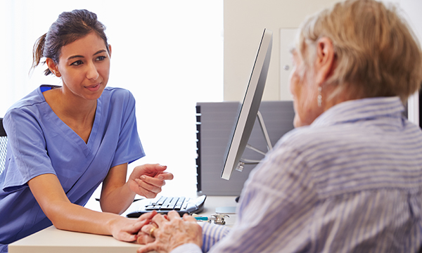 Photo of general practice nurse with patient, illustrating story about fellowship funding cut
