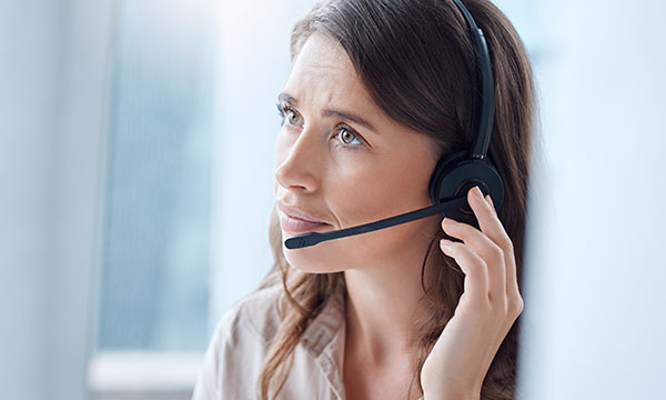 Helpline nursing can provide a crucial safety net; a nurse listens to a caller while wearing a headset 
