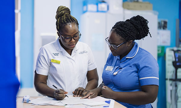 A nursing student on clinical placement working under supervision of a nurse