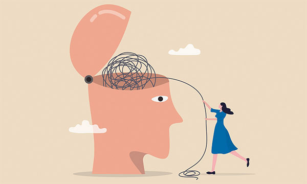 Illustration showing a gigantic open head containing a ball of black string that is being unravelled by a nurse who is standing to one side of the head