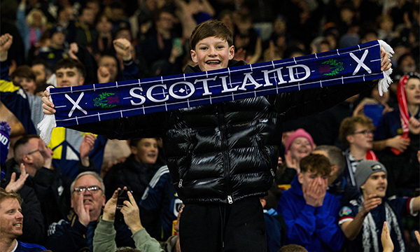Young boy in crowd of Scottish football supporters – nurses in Scotland's NHS to be included in bank holiday to celebrate men's football world cup 