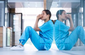 Ethical decision-making in practice: a nursing student sits on the floor in quiet contemplation