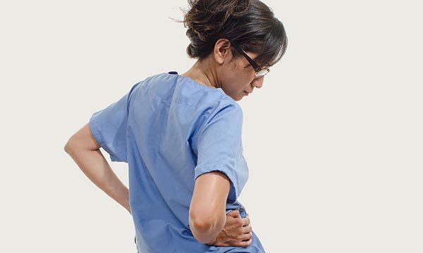 nurse rubs her back