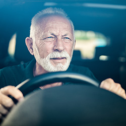 Dementia: picture shows a confused older man at the steering wheel of a car