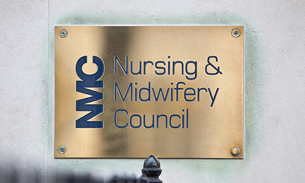 Brass wall plate showing the name of the NMC
