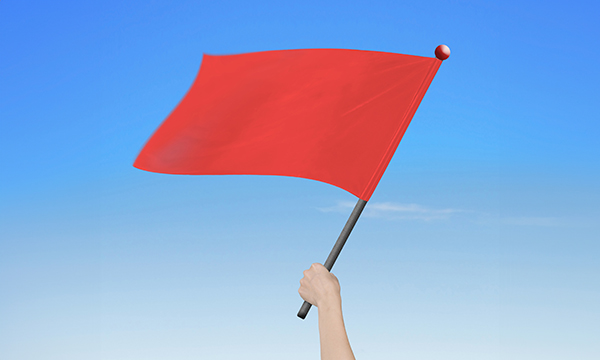  An illustration of a hand waving a large red flag in the air