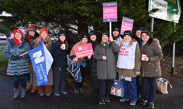 Strikers holding banners outside Ulster Hospital in Dundonald