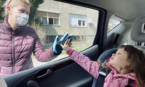 Picture shows a child in a car touching the window and a woman outside the car touching it from the other side.  A mental health charity has seen a jump in calls for help from nurses whose well-being is affected by pressure of choices they have to make.
