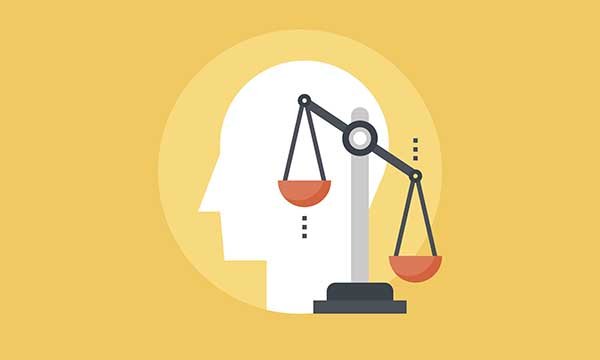 Vector illustration of scales of justice against background of profile of human head. The article says mental health nurses must safeguard the vulnerable if powers in Coronavirus Act 2020 are activated.