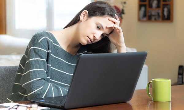 Picture shows young woman looking at her laptop screen. The Teenage Cancer Trust has shared advice on how to conduct difficult conversations digitally