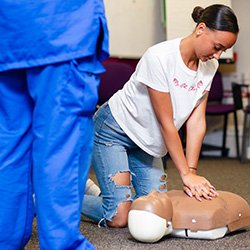 A YourStance workshop participant learning CPR