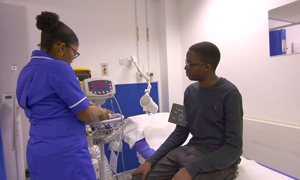 Transition specialist nurse Giselle Padmore-Payne tends to young patient David Ansa. Picture: BBC