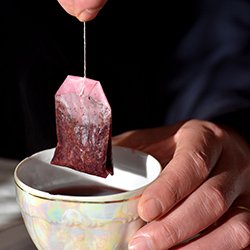 Herbal tea bag being dunked into a cup. One ward replaced ‘as required’ PRN medication with a wide selection of herbal teas