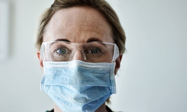 A woman wearing a face mask and visor Picture: iStock