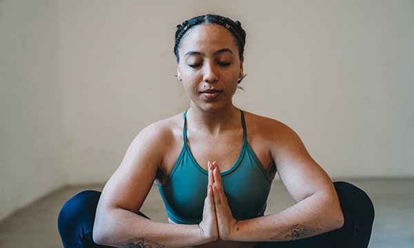 Woman in workout clothing practising meditation