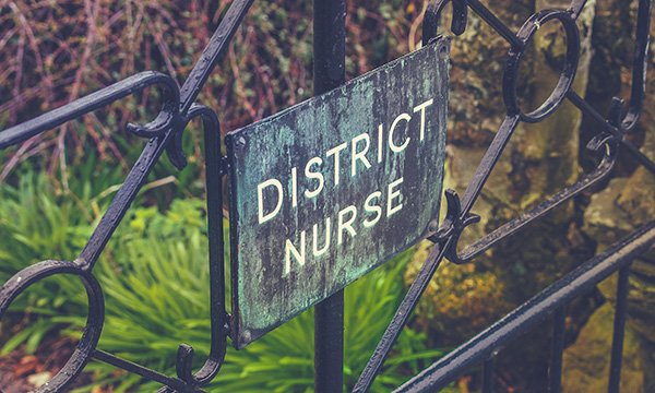 Sign saying district nurses – the district nursing specialist qualification had been under threat