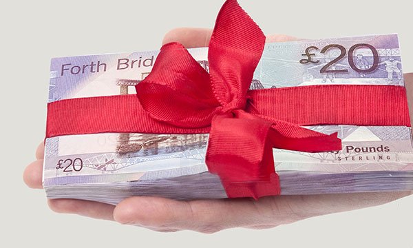 Picture shows a bundle of Scottish banknotes tied up in ribbon