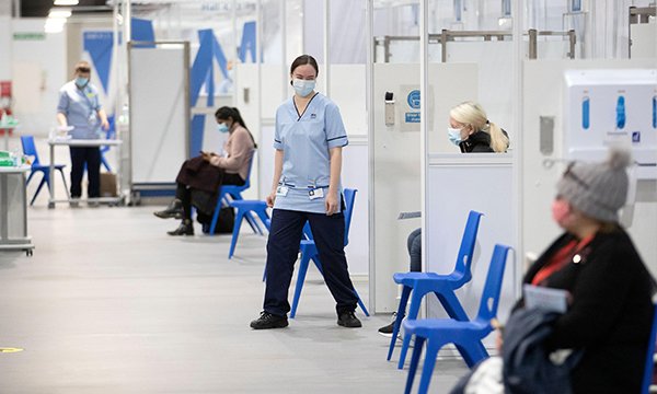 Health and social care staff wait in the rest area after receiving their coronavirus vaccines