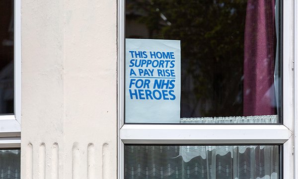 Poster in a window demonstrates public support for NHS pay rise