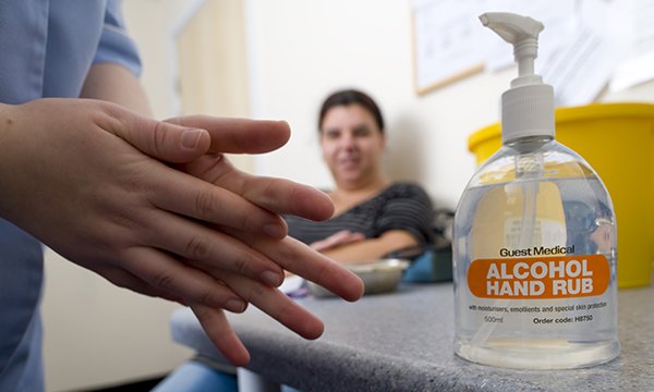 A person using alcohol hand gel