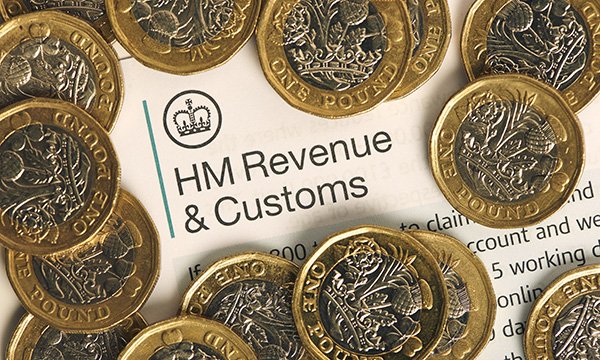 Picture showing an HMRC form covered with £1 coins 