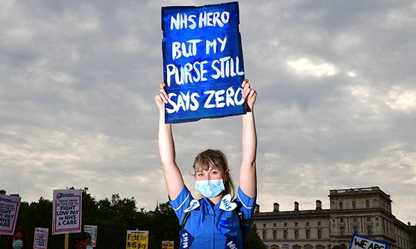 A nurse holds a placard during a protest over pay in central London