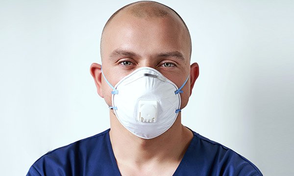Nurse wearing FFP3 respirator mask, which Cambridge study suggests reduces coronavirus infection incidence to almost zero among front-iine staff 