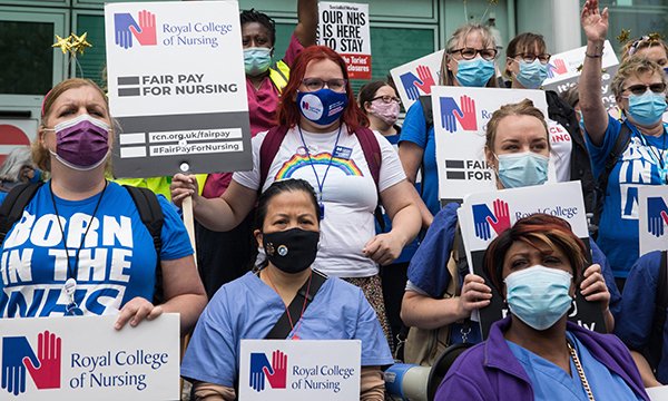 NHS nursing staff hold RCN banners as they set out on fair pay march to Whitehall in July 2021l