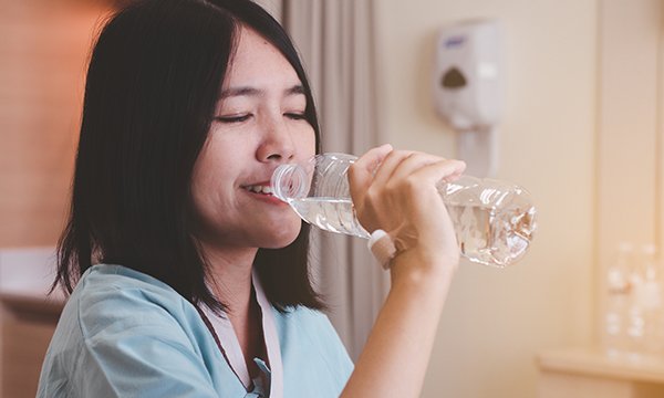 A nurse drinking water on shift