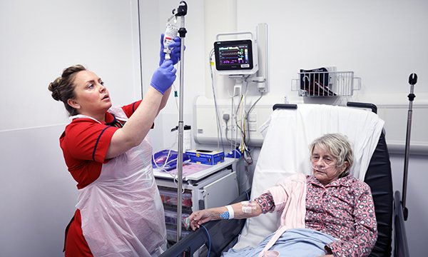 Sepis lead nurse Carrie Hayhurst demonstrates good practice by preparing an antibiotic IV infusion to patient Susan Elizabeth Corby at Leicester Royal Infirmary.