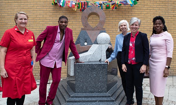 Photograph of people at the unveiling of the statue that honours the role of Windrush nurses at Whittington Hospital, London