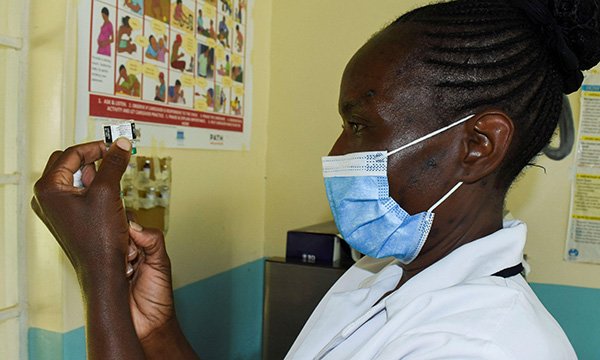 A nurse preparing a vaccine against Malaria for infants at the Yala Sub County Hospital, Kenya