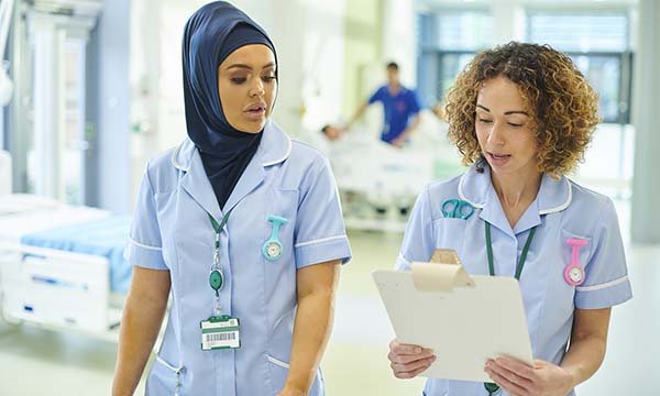 Picture of two female medics, one wearing a hijab or head scarf