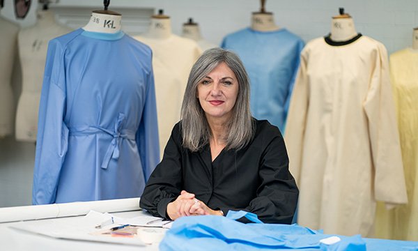 Photo of professor in fashion and textile practice Katherine Townsend with the prototype gowns