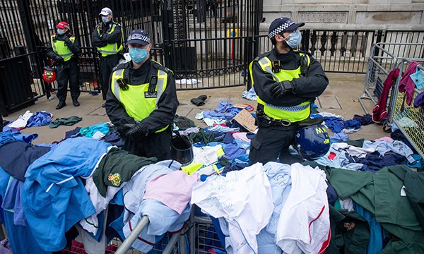 Nurses' scrubs piled in protest against compulsory COVID vaccination of staff, outside Downing Street