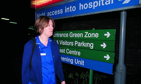 Picture shows a nurse arriving at a hospital entrance