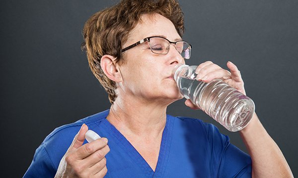 Picture of a nurse drinking bottled water