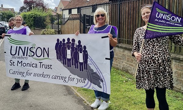 St Monica Trust care home staff on the picket line holding a Unison banner