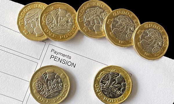Picture showing several £1 coins on a pension document