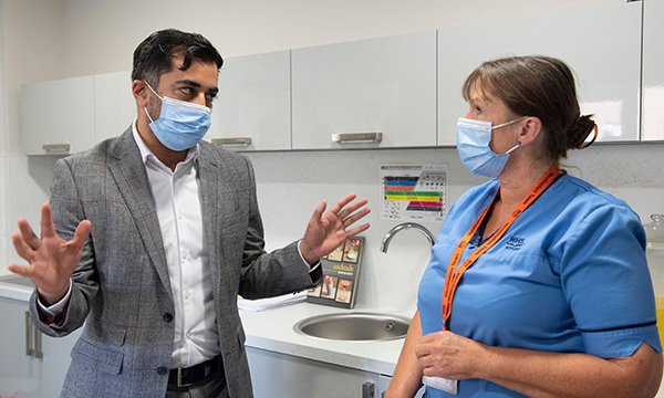 Scottish health secretary Humza Yousaf, who has announced the latest NHS pay offer, talks to an NHS nurse 