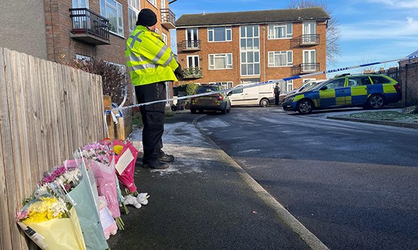 Flowers left next to a police cordon at the scene in Kettering where a nurse and her and two children were found injured