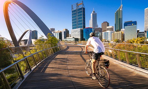 A man cycling over a bridge in Perth, capital of Western Australia