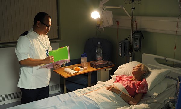 Photo of nurse with a patient during a night shift
