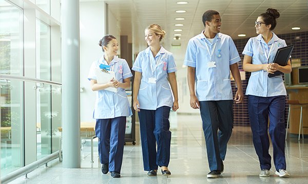 A group of nurses strolling and chatting in a hospital 